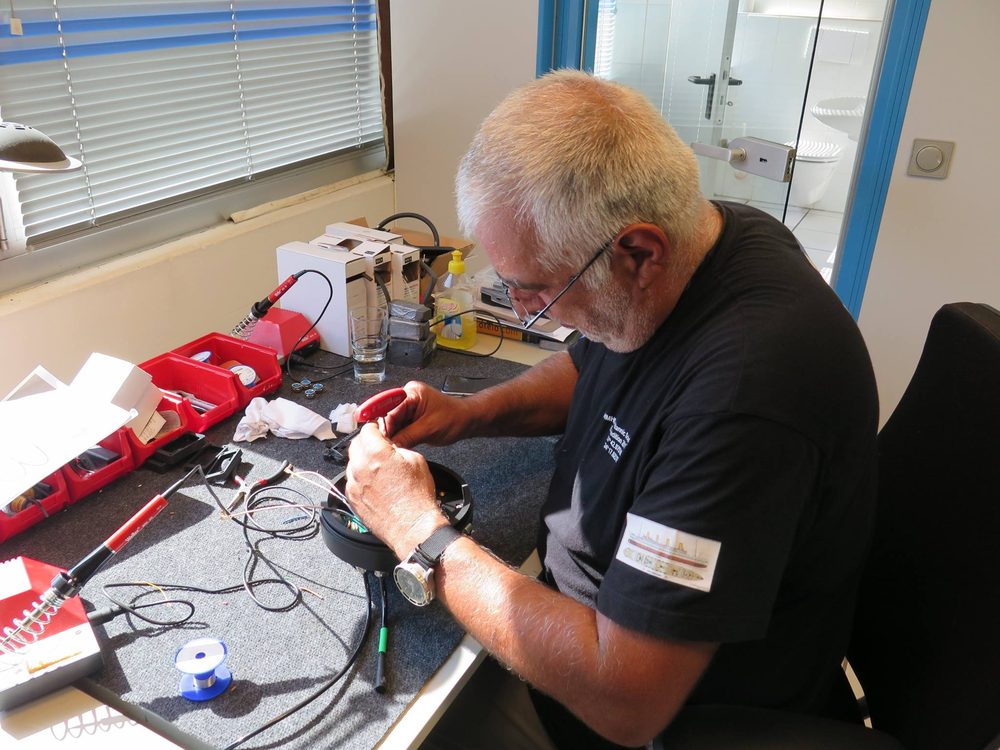 Scubalab technician repairing diving equipment at the workbench